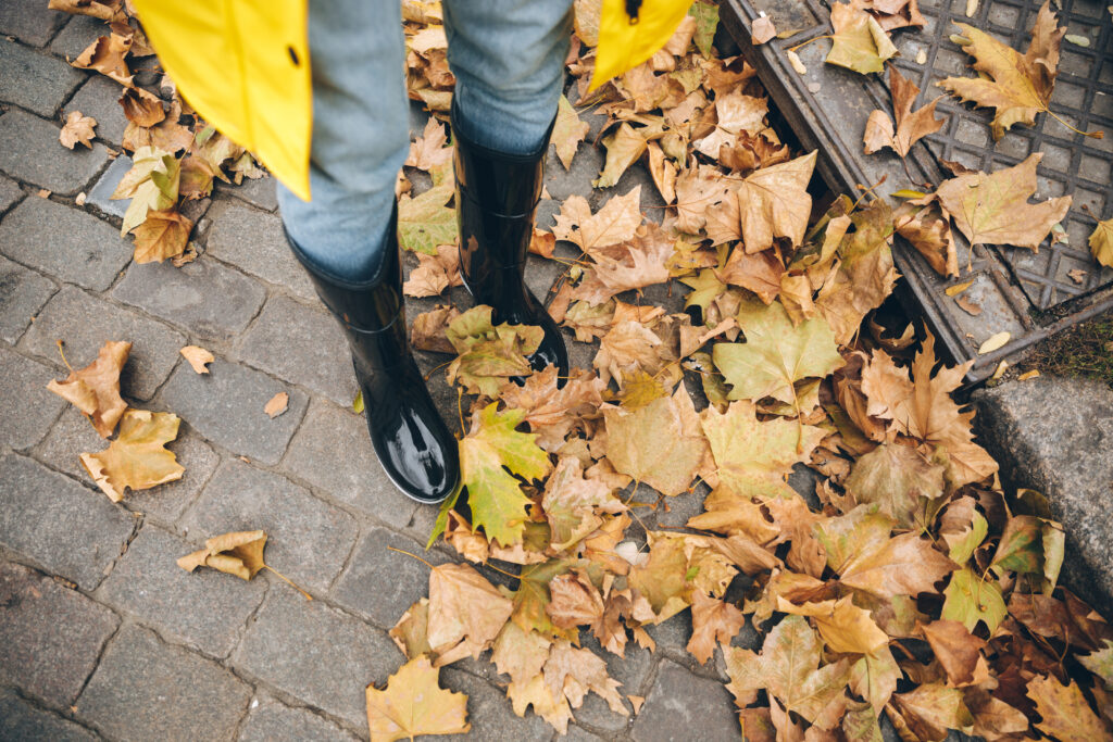 Close-up of person wearing rubber boots outdoors