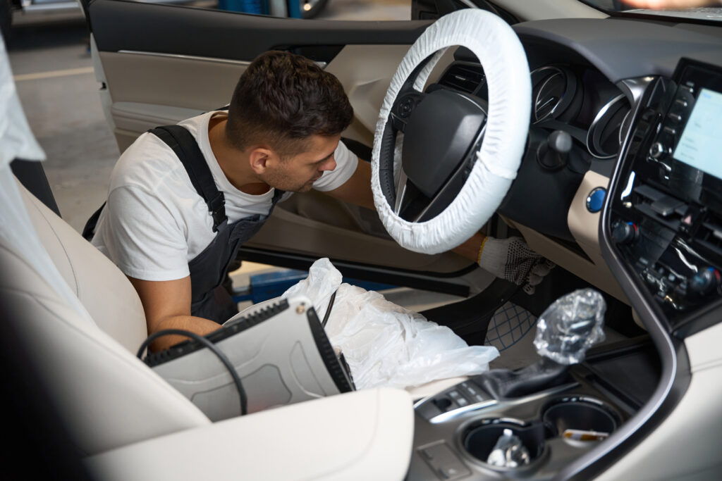 Mechanic checking technical condition of car in service station