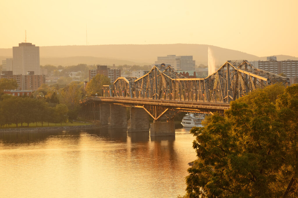 Ottawa city skyline at sunset with warm colors reflecting on buildings