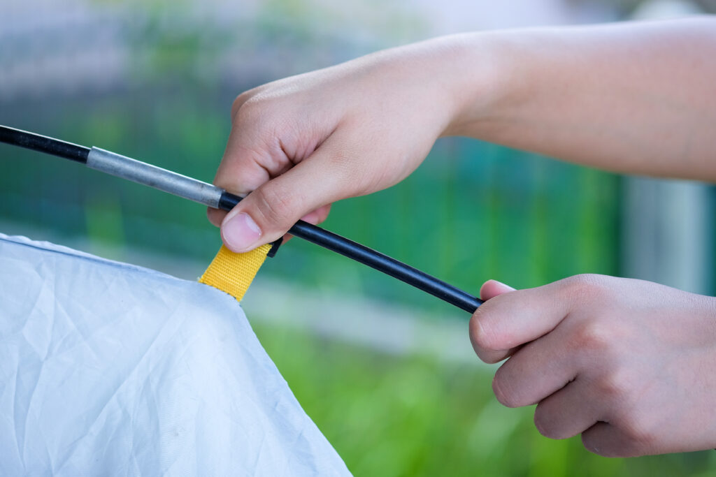 Traveler setting up tents at outdoor camping site