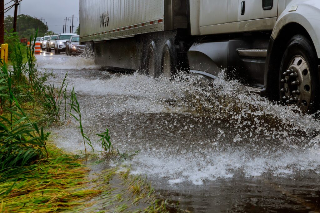 Car driving through flooded road after heavy rain